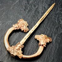 Bronze brooch - face of a dragon